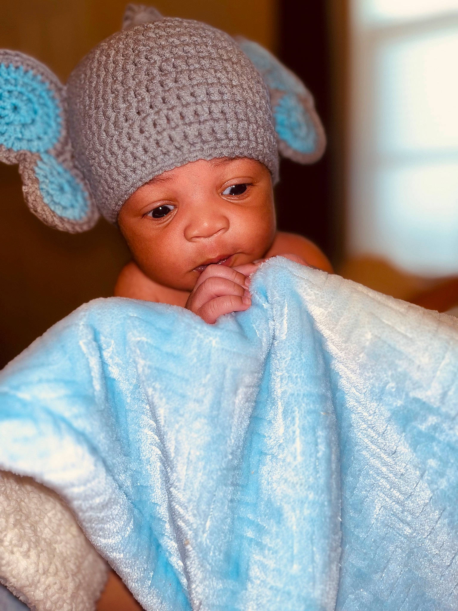 Kartier is registered to the contest to win money with this photo: art, azure, baby, blue, cap, cheek, child, creative_arts, electric_blue, eye, eyelash, fashion_accessory, head, headgear, headwear, knit_cap, magenta, person, textile, toy