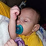 Enzo is registered to the contest to win money with this photo: baby, sleeping, pacifier, blanket, yellow_shirt, infant, child, cozy, peaceful, closeup, face, hand, skin, ear, eyelashes, soft, comfort, indoor, rest, cute