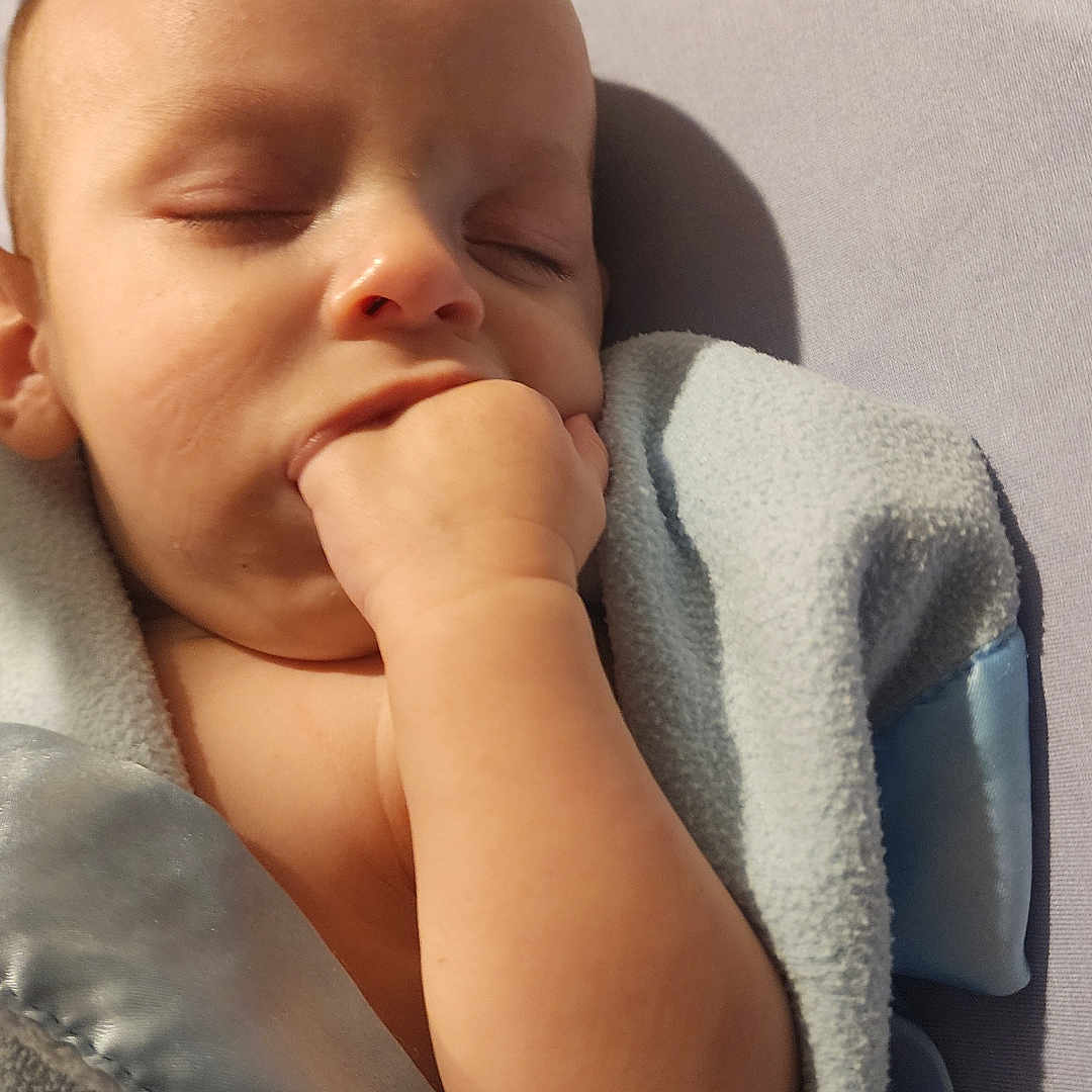 Enzo is registered to the contest to win money with this photo: baby, blanket, child, cozy, cute, face, fingers, hand, head, indoors, infant, mouth, nap, pacifier, peaceful, rest, skin, sleeping, soft, toy