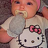 baby, infant, pacifier, pink_headband, mittens, hello_kitty, onesie, cute, child, portrait, face, apparel, indoor, soft_texture, closeup, newborn, baby_clothing, lying_down, adorable, young_child