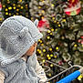 toddler, child, hoodie, blue, shopping_cart, holiday, christmas_tree, lights, bokeh, winter_clothing, cute, profile, fuzzy, ears, indoor, seasonal, decorations, festive, baby, person