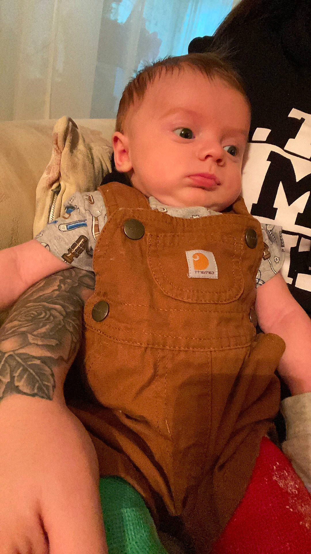Oaklen is registered to the contest to win money with this photo: baby, baby_products, baby_toddler_clothing, button, cheek, child, eye, flesh, human, iris, joint, overall, peach, person, skin, tattoo, temporary_tattoo, toddler