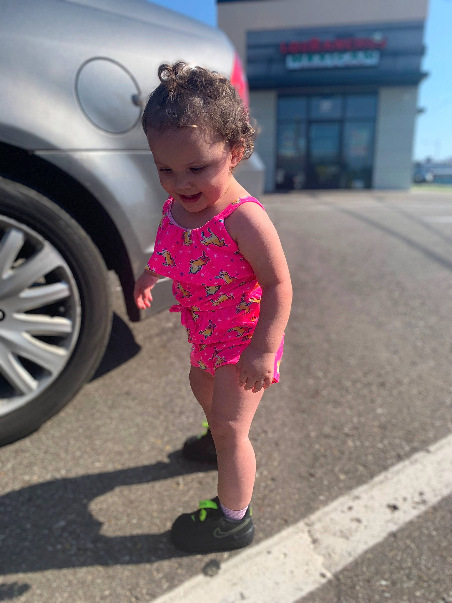 Nyomi is registered to the contest to win money with this photo: alloy_wheel, asphalt, automotive_design, automotive_exterior, automotive_lighting, automotive_tire, bumper, car, dress, electric_blue, fender, hood, joy, motor_vehicle, person, rim, road, road_surface, tire, toddler