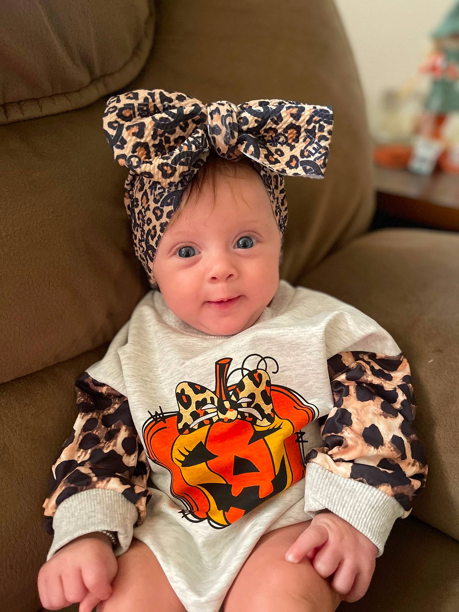 Kaiya is registered to the contest to win money with this photo: baby, baby_toddler_clothing, cap, child, comfort, costume_hat, eye, fun, happy, head, headwear, human_body, lap, pattern, person, sitting, sleeve, smile, t_shirt, textile