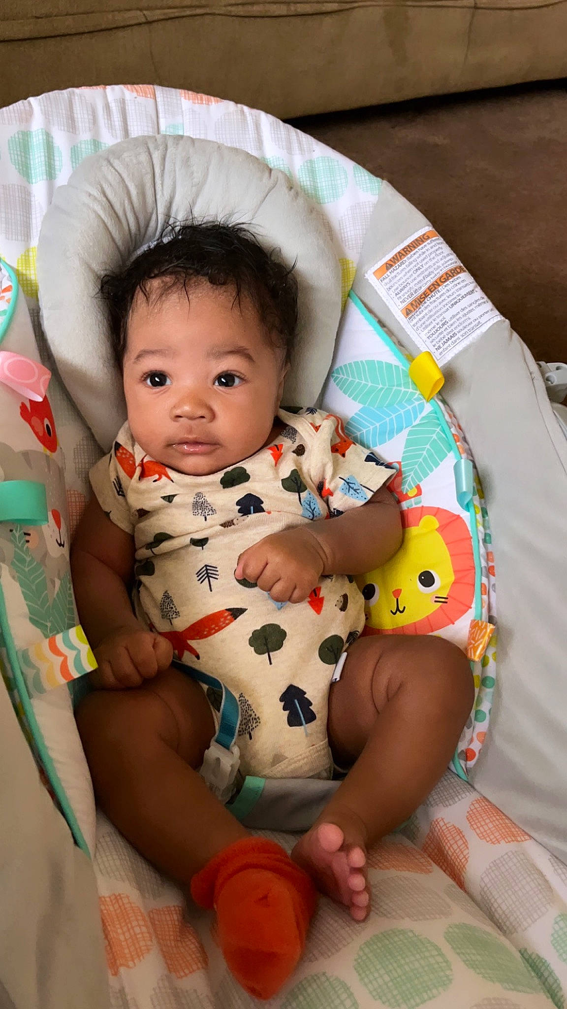 Dakari is registered to the contest to win money with this photo: abdomen, arm, baby, baby_products, baby_toddler_clothing, chair, cheek, chest, child, comfort, foot, lap, leg, person, sitting, skin, sleeve, stomach, thigh, toddler