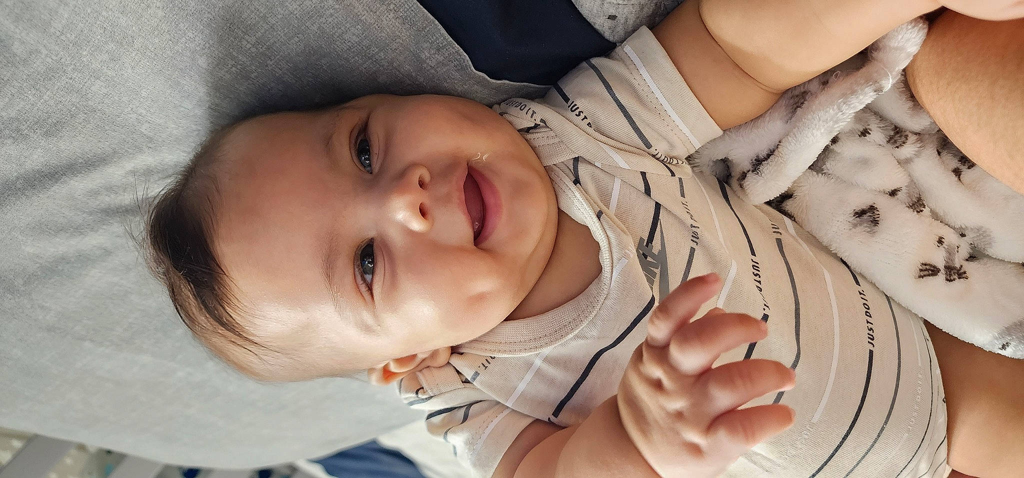 Natanael is registered to the contest to win money with this photo: baby, baby_toddler_clothing, cheek, chin, eye, eyebrow, facial_expression, gesture, hand, lip, mammal, mouth, nose, organ, person, product, skin, sleeve, smile, vertebrate