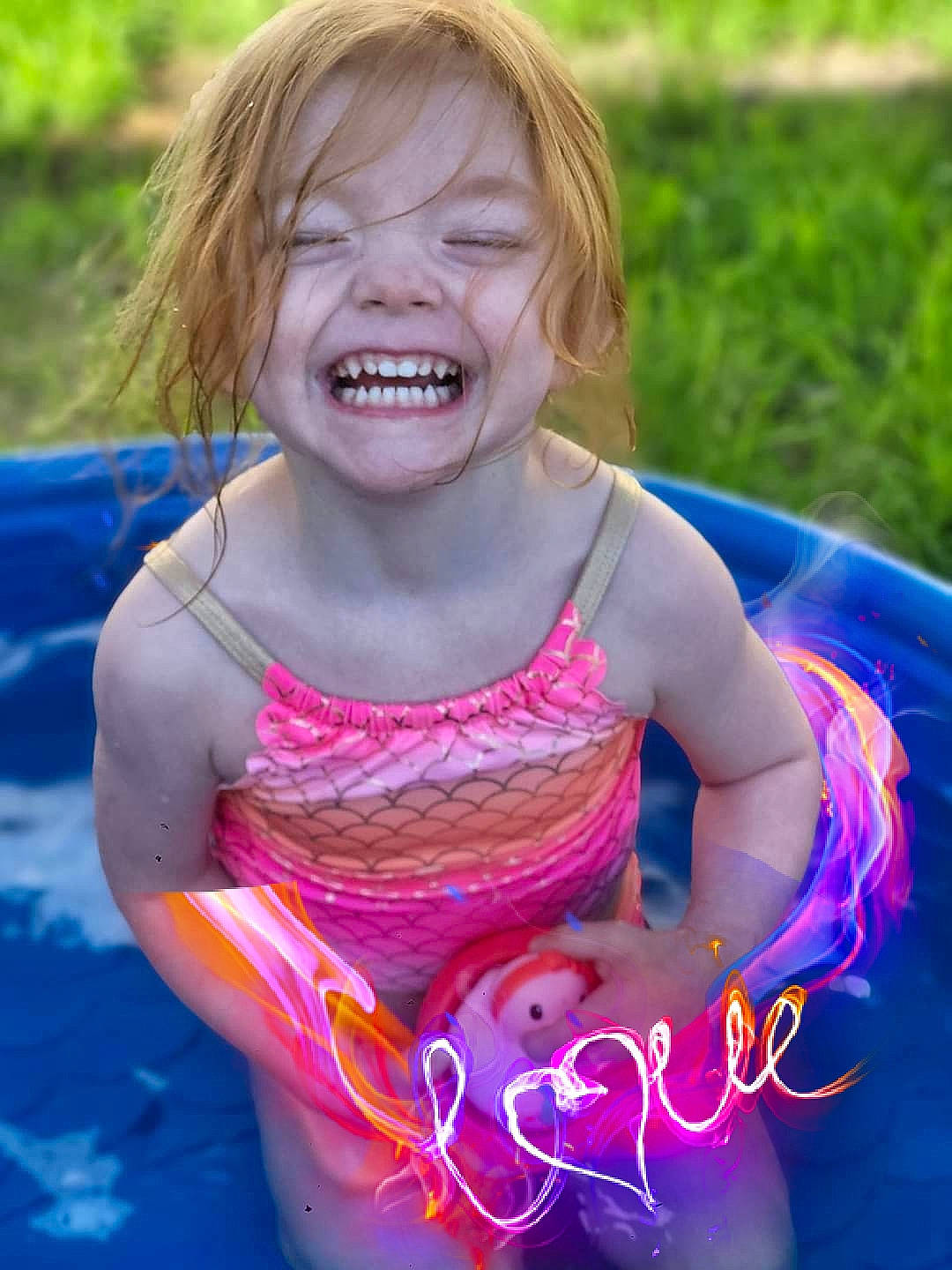 Serenity-lynn joined the competition — help win amazing prizes! blue, child, electric_blue, facial_expression, fun, grass, happy, joy, leisure, magenta, people_in_nature, person, pink, play, recreation, sitting, smile, summer, swimming_pool, swimwear