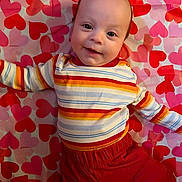 Quentin joined the competition — help win amazing prizes! adorable, baby, blanket, child, closeup, clothing, cute, eyes, face, happy, hearts_background, indoors, infant, lying_down, pattern, portrait, red_pants, rosy_cheeks, smile, striped_shirt