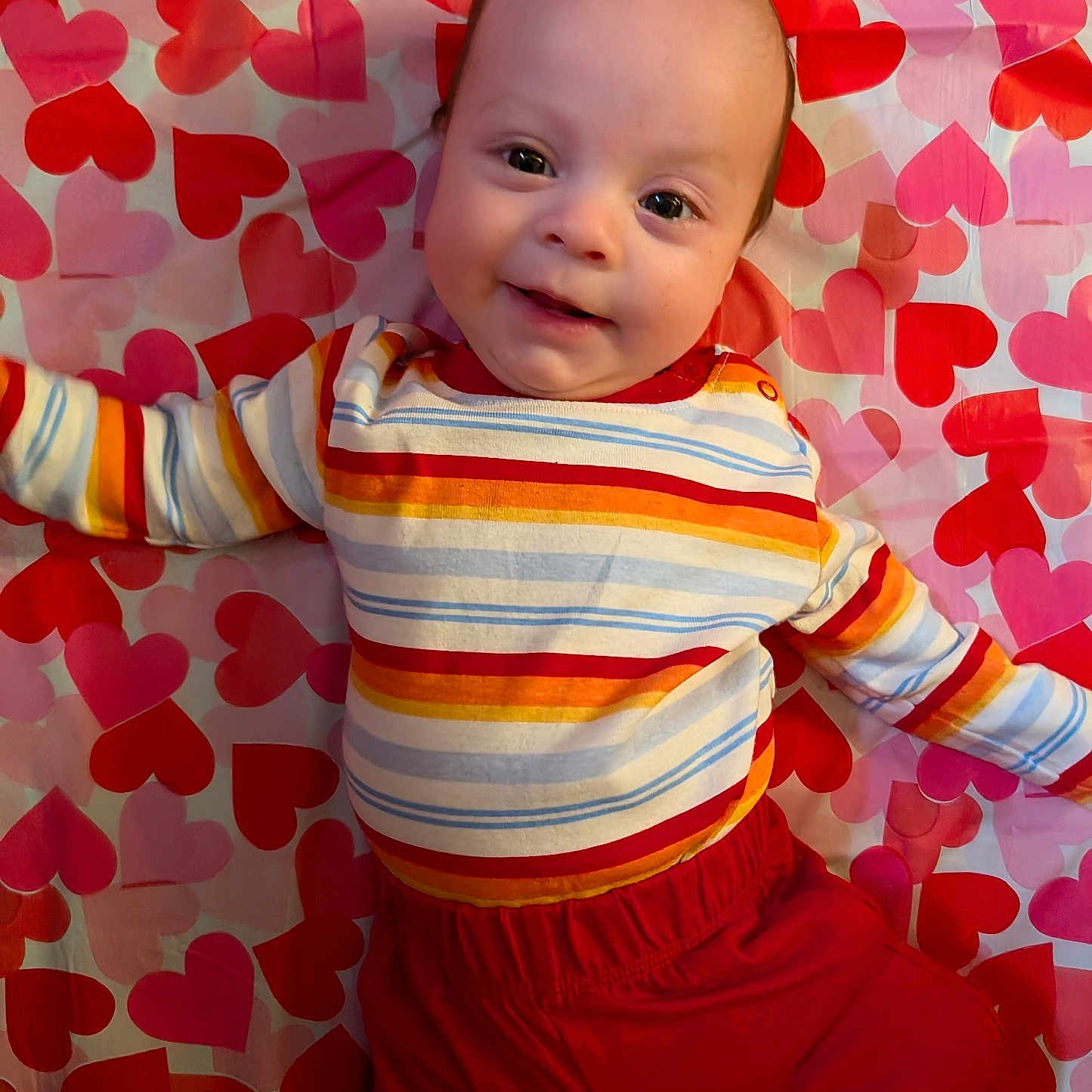 Quentin joined the competition — help win amazing prizes! adorable, baby, blanket, child, closeup, clothing, cute, eyes, face, happy, hearts_background, indoors, infant, lying_down, pattern, portrait, red_pants, rosy_cheeks, smile, striped_shirt