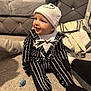 Ronnie Trevor is registered to the contest to win money with this photo: baby, bag, black_and_white, carpet, child, costume, couch, cute, happy, hat, home, indoor, infant, jack_skellington, pacifier, person, sitting, smiling, soft_lighting, striped_clothing