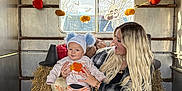 Ronnie Trevor is registered to the contest to win money with this photo: autumn, baby, bat, child, cozy, cute, decoration, festive, halloween, hat, hay, indoor, long_hair, orange_stripes, plaid_shirt, pumpkin, skull, smile, window, woman