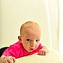 Ronnie Trevor joined the competition — help win amazing prizes! baby, infant, child, pink_shirt, face, expression, curious, lying_down, hand, skin, head, eyes, indoor, soft_surface, light, portrait, young, person, cute, closeup