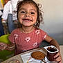 casual_clothing, child, chocolate, cookie, curly_hair, cute, dining, food, girl, happy, indoor, messy, napkin, person, pink_shirt, portrait, pudding, smiling, spoon, table
