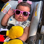 Adalina Lopez is registered to the contest to win money with this photo: baby, child, infant, stroller, sunglasses, pink_sunglasses, flower_hair_clips, stuffed_toy, yellow_toy, seated, portrait, outdoor, vehicle, safety_harness, curly_hair, looking_at_camera, playful, colorful, baby_carriage, casual