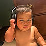Charlee joined the competition — help win amazing prizes! toddler, child, headphones, toy, bare_chest, indoor, furniture, dresser, carpet, curly_hair, cute, chubby, serious, person, baby, skin, hand, playing, room, young_child
