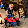 Bryar joined the competition — help win amazing prizes! toddler, toy, ride_on_toy, spiderman, indoor, living_room, christmas_tree, furniture, carpet, child, cute, playtime, table, chair, floor_tiles, window, holiday, decor, happy, person