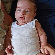 Kenzyo participe au concours pour gagner de l'argent avec cette photo : baby, bed, blanket, child, chubby, comfort, curly_hair, cute, expression, hand, holding_hand, indoors, infant, lying_down, onesie, person, skin, soft, tenderness, white_clothing