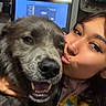 affection, animal, casual, closeup, clothing, couch, dog, face, friendship, happy, hug, indoor, kiss, long_hair, nose_ring, person, pet, smile, television, wall_art