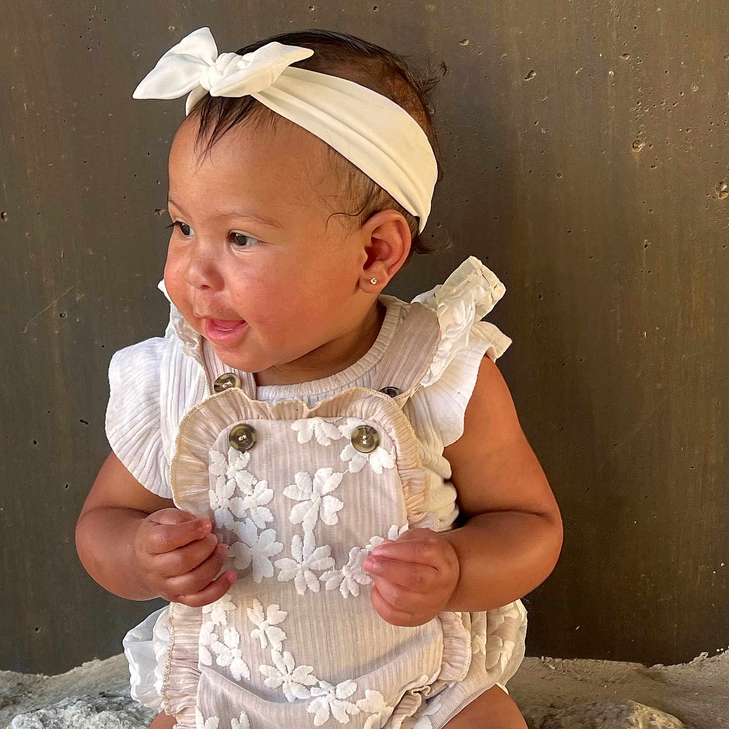 Xinovia is registered to the contest to win money with this photo: accessories, baby, bodypart, clothing, cream, diaper, dress, face, finger, hand, hat, head, headband, jewelry, necklace, person, photography, portrait, sitting, sleeve