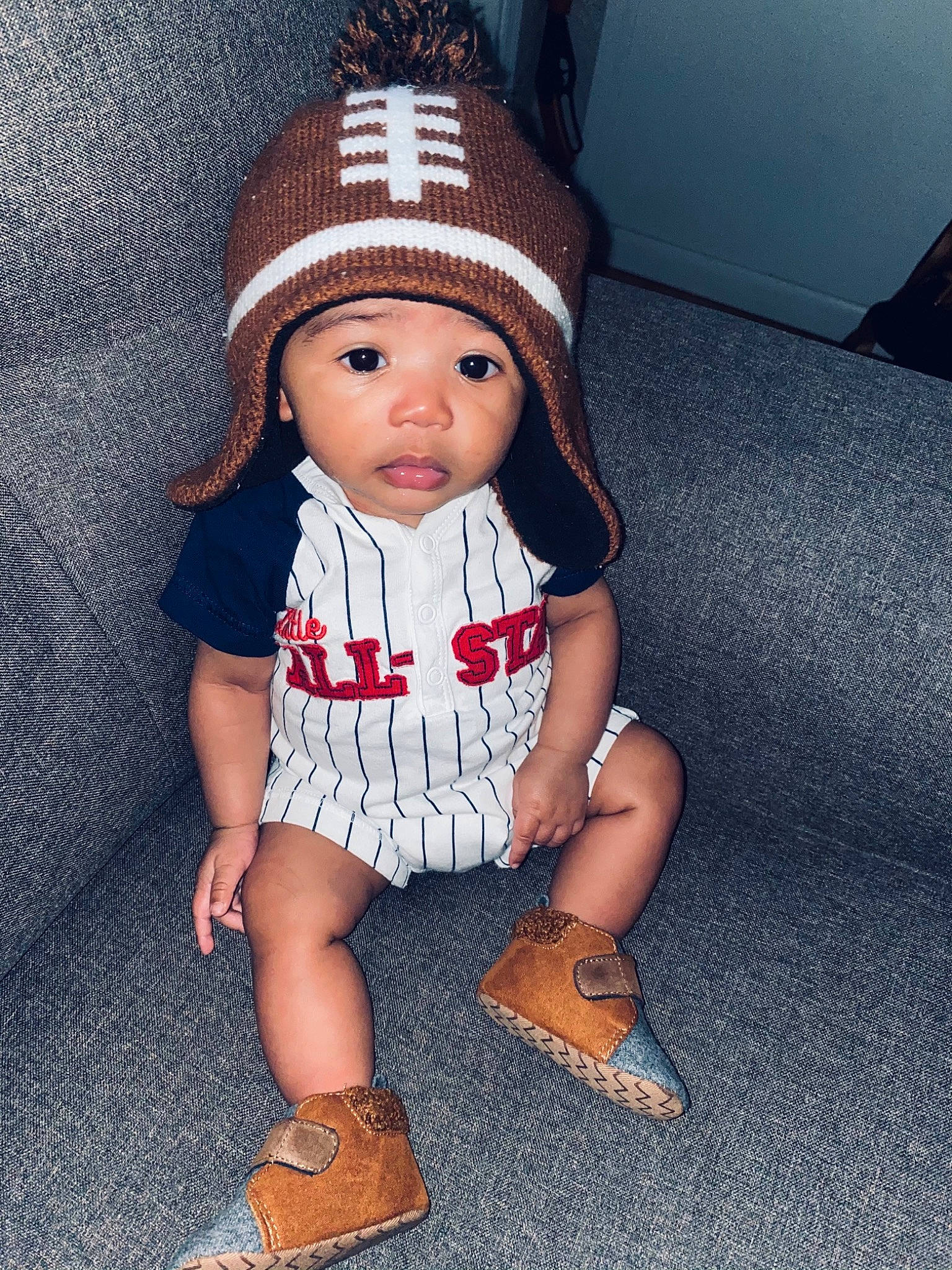 Quade is registered to the contest to win money with this photo: beanie, bonnet, cap, cheek, child, clothing, crochet, doll, fashion_accessory, footwear, hat, head, headgear, headwear, knit_cap, knitting, person, shoe, sitting, skin