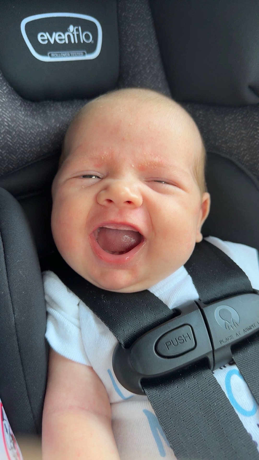 Cody joined the competition — help win amazing prizes! baby, infant, car_seat, harness, white_clothing, smiling, happy, child, cute, closeup, seatbelt, infant_seat, baby_face, child_safety, car_interior, young_child, person, human, baby_expression, transportation