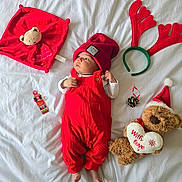 Rihan joined the competition — help win amazing prizes! baby, red_overalls, red_hat, teddy_bear, christmas, holiday, bed, white_bed_sheet, reindeer_antlers, pine_cone, plush_toy, infant, cute, festive, decorations, lying_down, soft_toy, christmas_hat, child, indoors