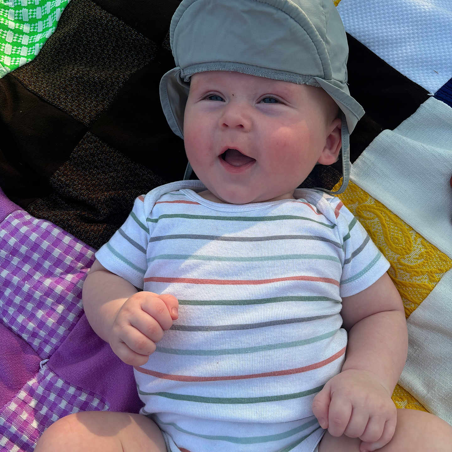 Hudson is registered to the contest to win money with this photo: baby, baseballcap, bodypart, bonnet, cap, clothing, face, finger, hand, happy, hat, head, laughing, newborn, person, photography, portrait, shorts, sunhat, t_shirt