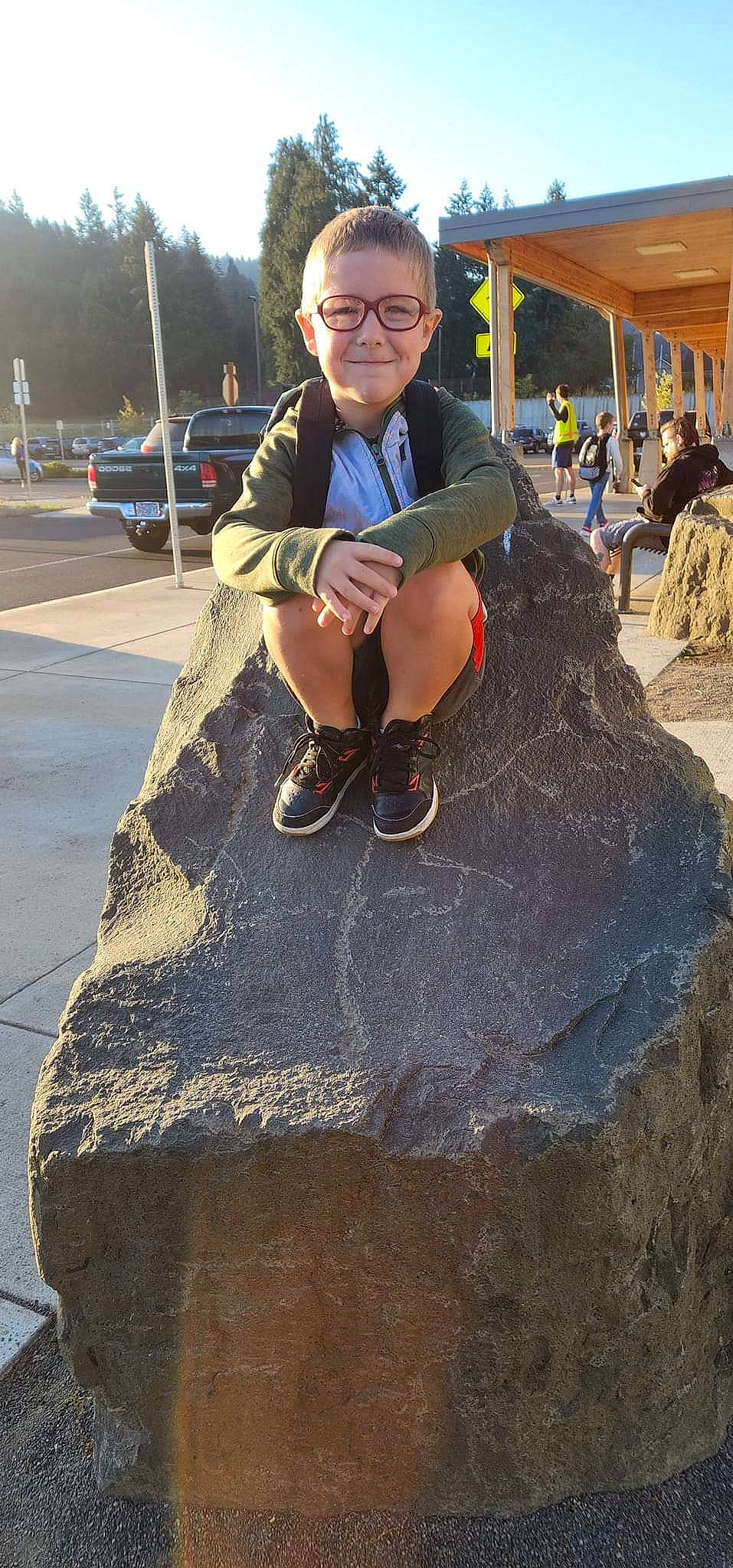 Collen joined the competition — help win amazing prizes! asphalt, concrete, eyewear, fashion_accessory, fun, human_leg, joy, leisure, person, public_space, recreation, road_surface, rock, shadow, sidewalk, sitting, smile, soil, t_shirt, tie