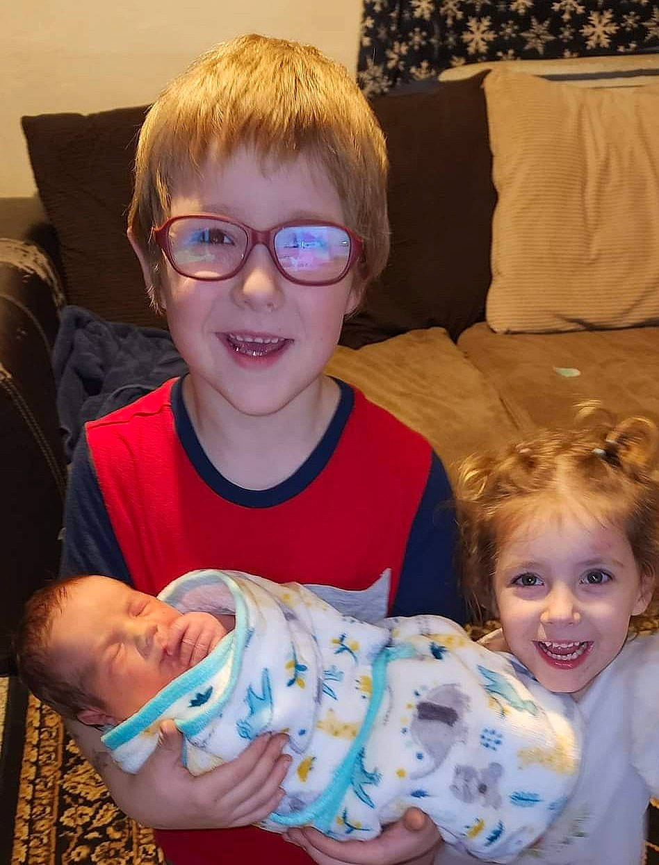 Collen is registered to the contest to win money with this photo: baby_toddler_clothing, blue, cheek, chin, comfort, couch, eye, face, facial_expression, glasses, happy, head, human, human_body, iris, joy, organ, person, skin, smile