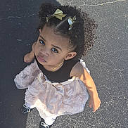 Jasmine joined the competition — help win amazing prizes! child, girl, curly_hair, dress, bows, shoes, outdoor, pavement, shadow, sunlight, fashion, portrait, looking_up, young_child, person, cute, standing, accessory, daylight, expression