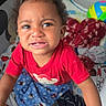 toddler, child, red_shirt, playpen, blanket, toy_ball, baby_bottle, indoor, expression, curly_hair, person, young_child, upset, confused, colorful, soft_light, casual_clothing, floor, baby, play_area