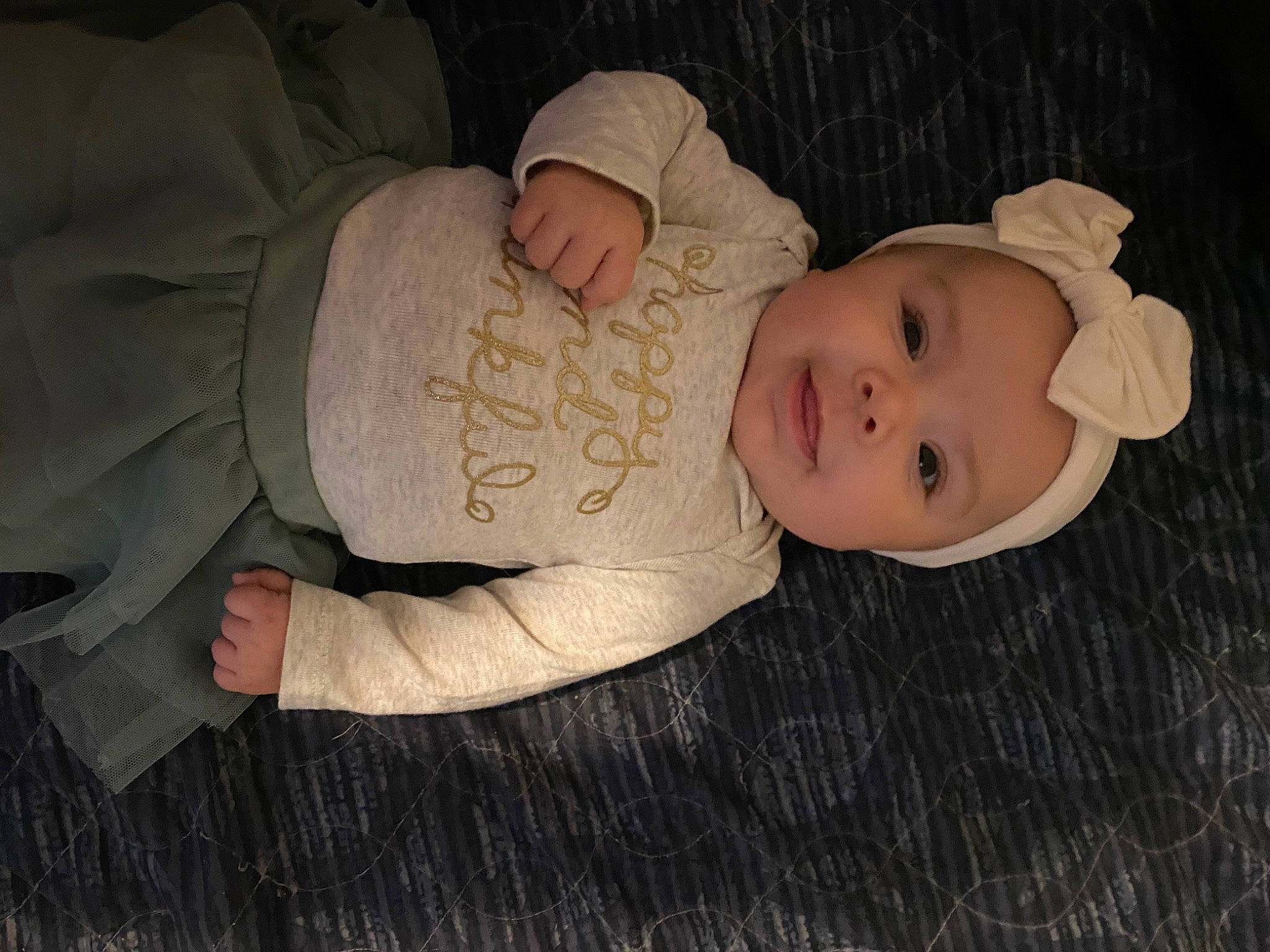 Paula is registered to the contest to win money with this photo: baby, baby_products, baby_toddler_clothing, cheek, child, comfort, headgear, headwear, human_body, person, sitting, skin, sleeve, toddler, wood