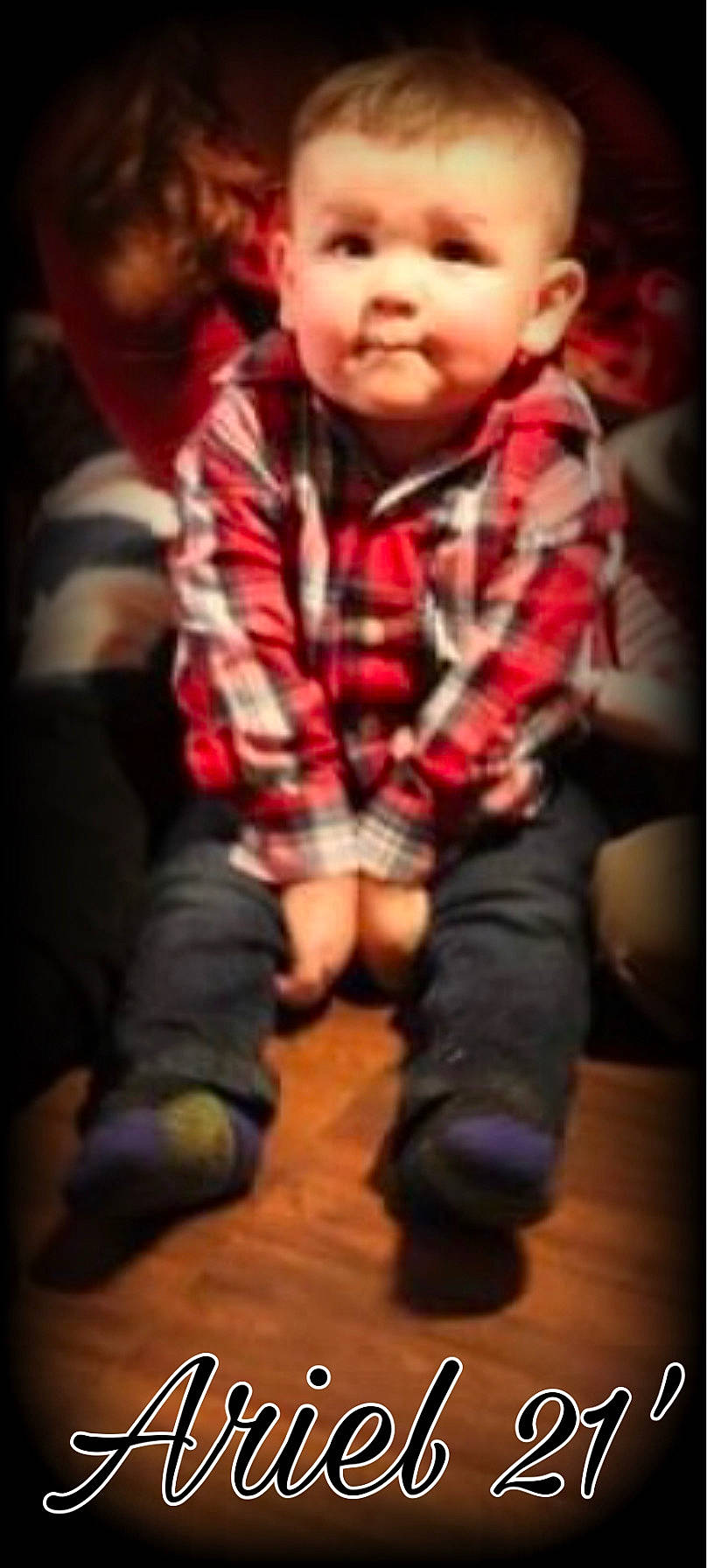 Ariel is registered to the contest to win money with this photo: baby, baby_toddler_clothing, black, cheek, cool, finger, flooring, fun, gesture, happy, hardwood, mouth, nose, pattern, person, sitting, sleeve, thigh, thumb, toddler