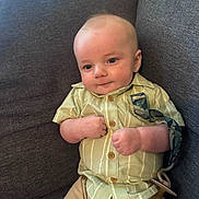 Sheperd joined the competition — help win amazing prizes! baby, child, infant, couch, clothing, shirt, shorts, pacifier, face, smile, sitting, indoor, furniture, cute, expression, young, person, relaxing, comfort, portrait