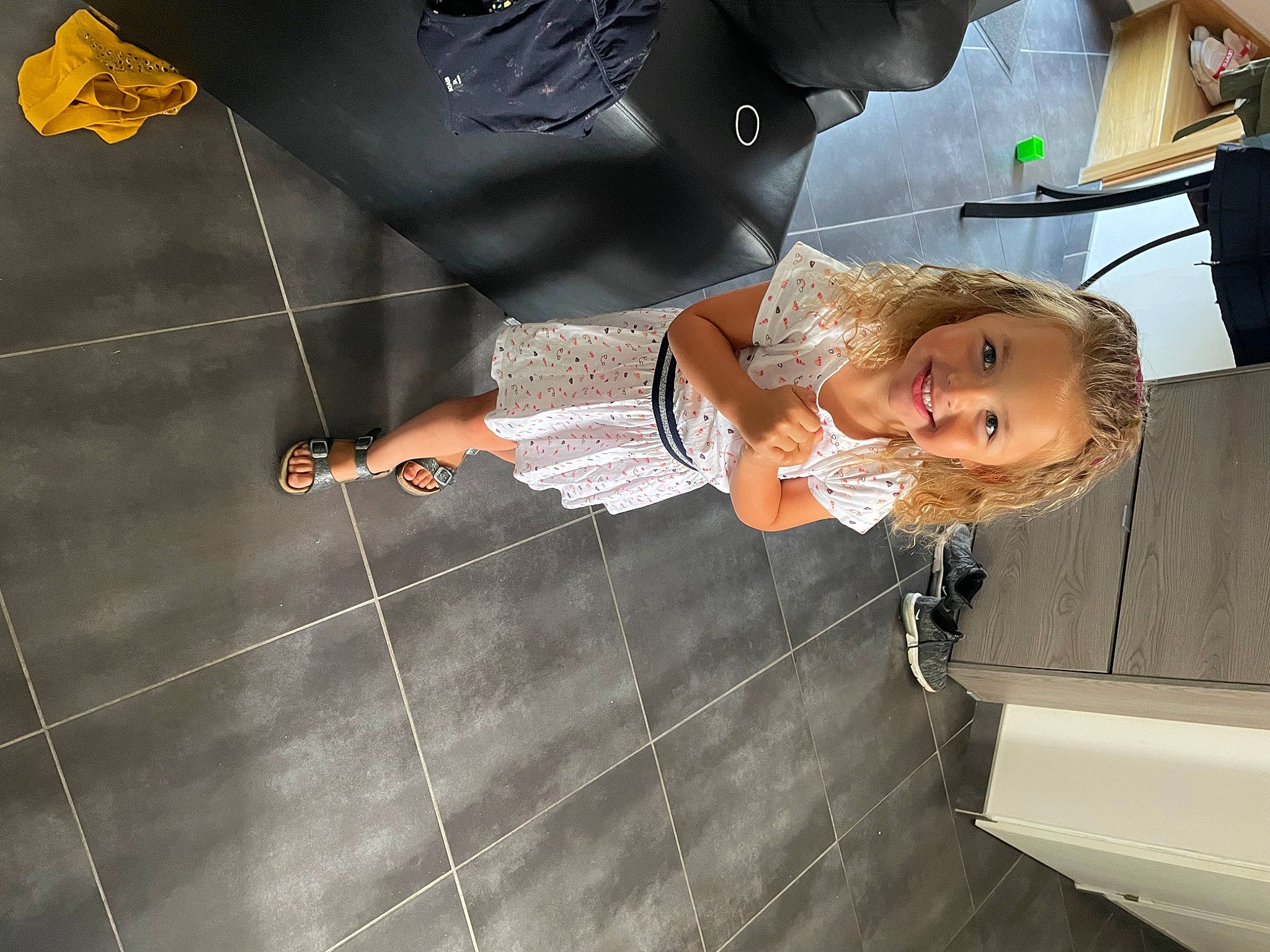 Nina participe au concours pour gagner de l'argent avec cette photo : child, dress, flash_photography, flooring, fun, gesture, happy, joy, person, room, smile, toddler