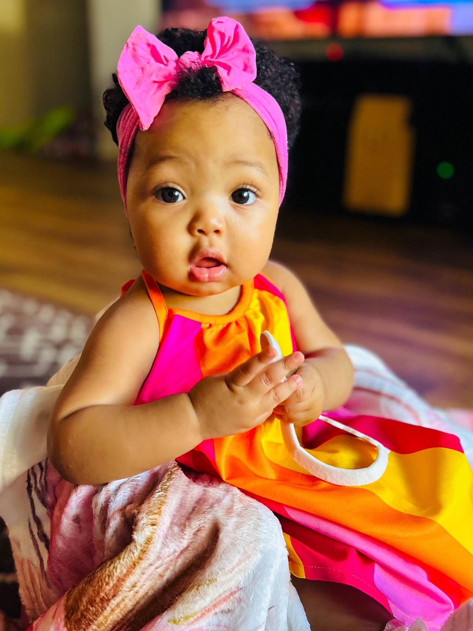 Zenovia is registered to the contest to win money with this photo: baby, baby_toddler_clothing, child, event, eyelash, fashion_accessory, fun, hair_accessory, happy, headband, headpiece, leisure, magenta, peach, person, pink, purple, sitting, skin, smile