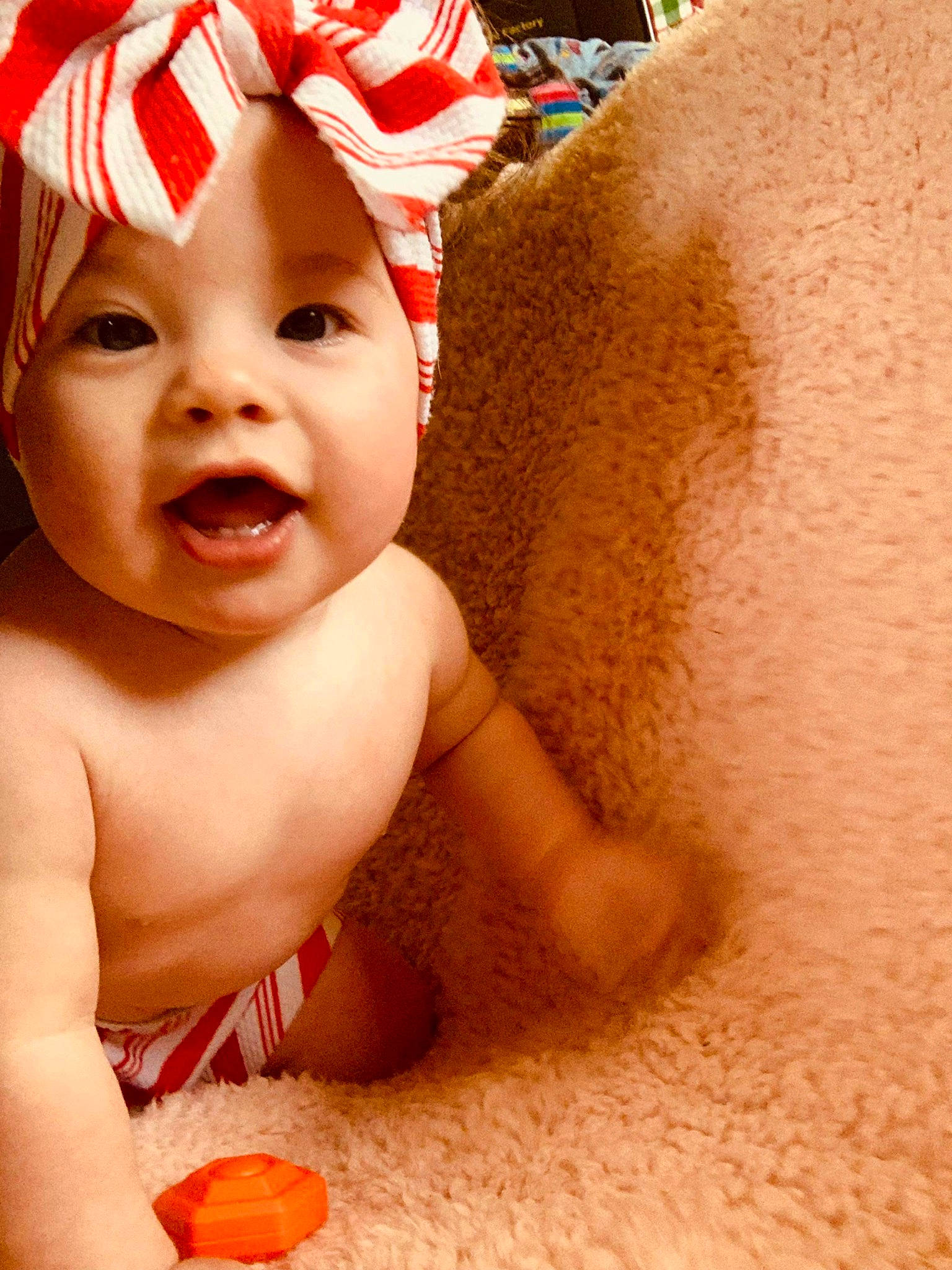 Davina is registered to the contest to win money with this photo: arm, baby, baby_laughing, baby_making_funny_faces, baby_playing_with_toys, baby_products, baby_toddler_clothing, bathing, cap, chest, child, facial_expression, finger, fun, happy, headwear, lip, mouth, nose, person