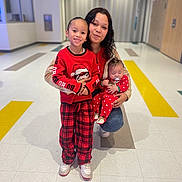 Amaiahkali joined the competition — help win amazing prizes! woman, child, baby, red_clothing, pajamas, smiling, pacifier, indoor, hallway, floor_tiles, plaid_pants, holding, family, portrait, happy, casual, kneeled, long_hair, cute, holiday