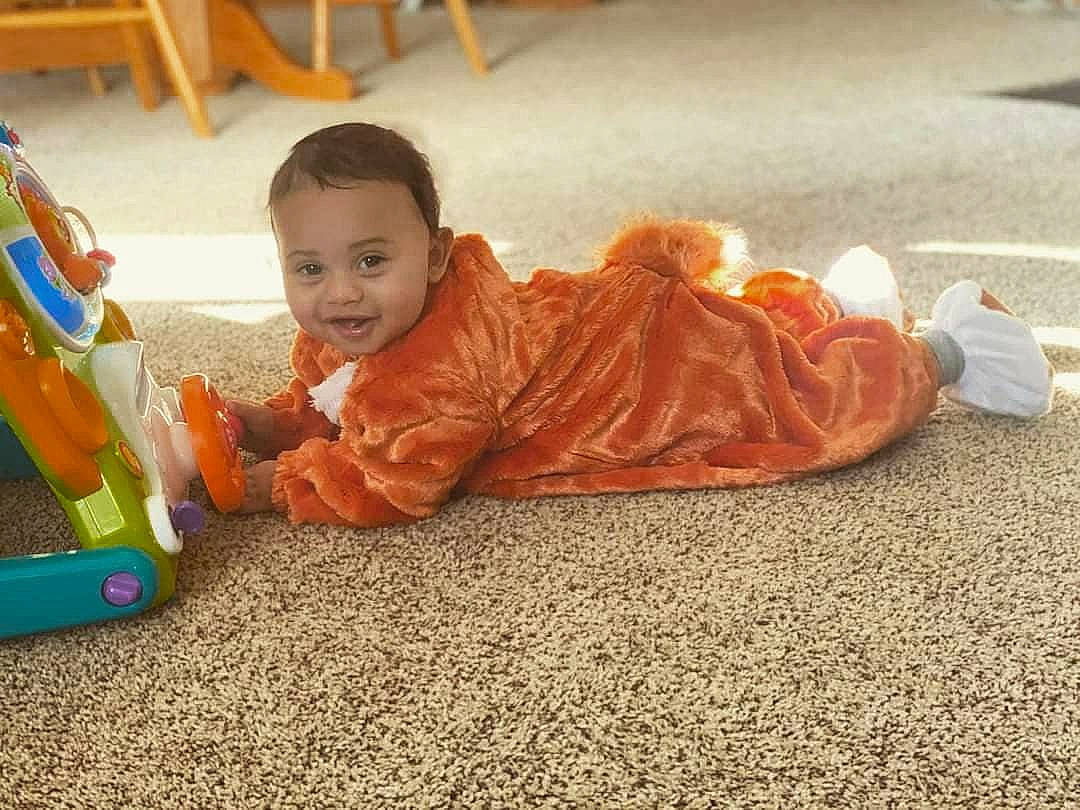 Leon is registered to the contest to win money with this photo: baby, child, floor, flooring, person, play, sitting, toddler, tummy_time