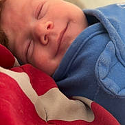 Cooper joined the competition — help win amazing prizes! baby, sleeping, smile, blue_clothing, blanket, closeup, face, peaceful, infant, resting, cozy, child, portrait, cute, soft_light, indoor, young, toddler, comfort, relaxation