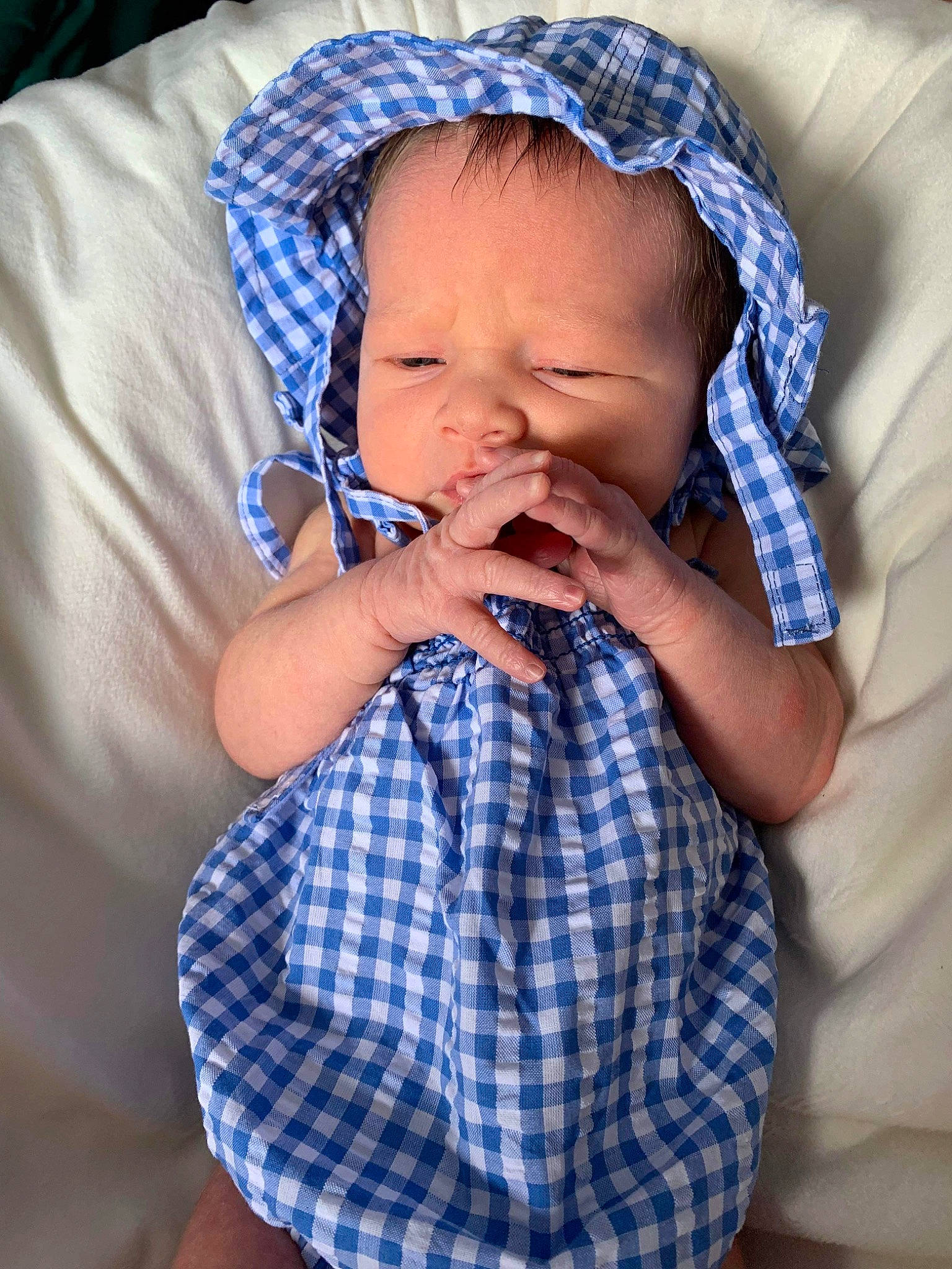Juniper is registered to the contest to win money with this photo: baby, baby_toddler_clothing, cheek, chin, comfort, finger, gesture, hairstyle, head, iris, lip, mouth, nose, person, purple, skin, sleeve, tartan, textile, toddler