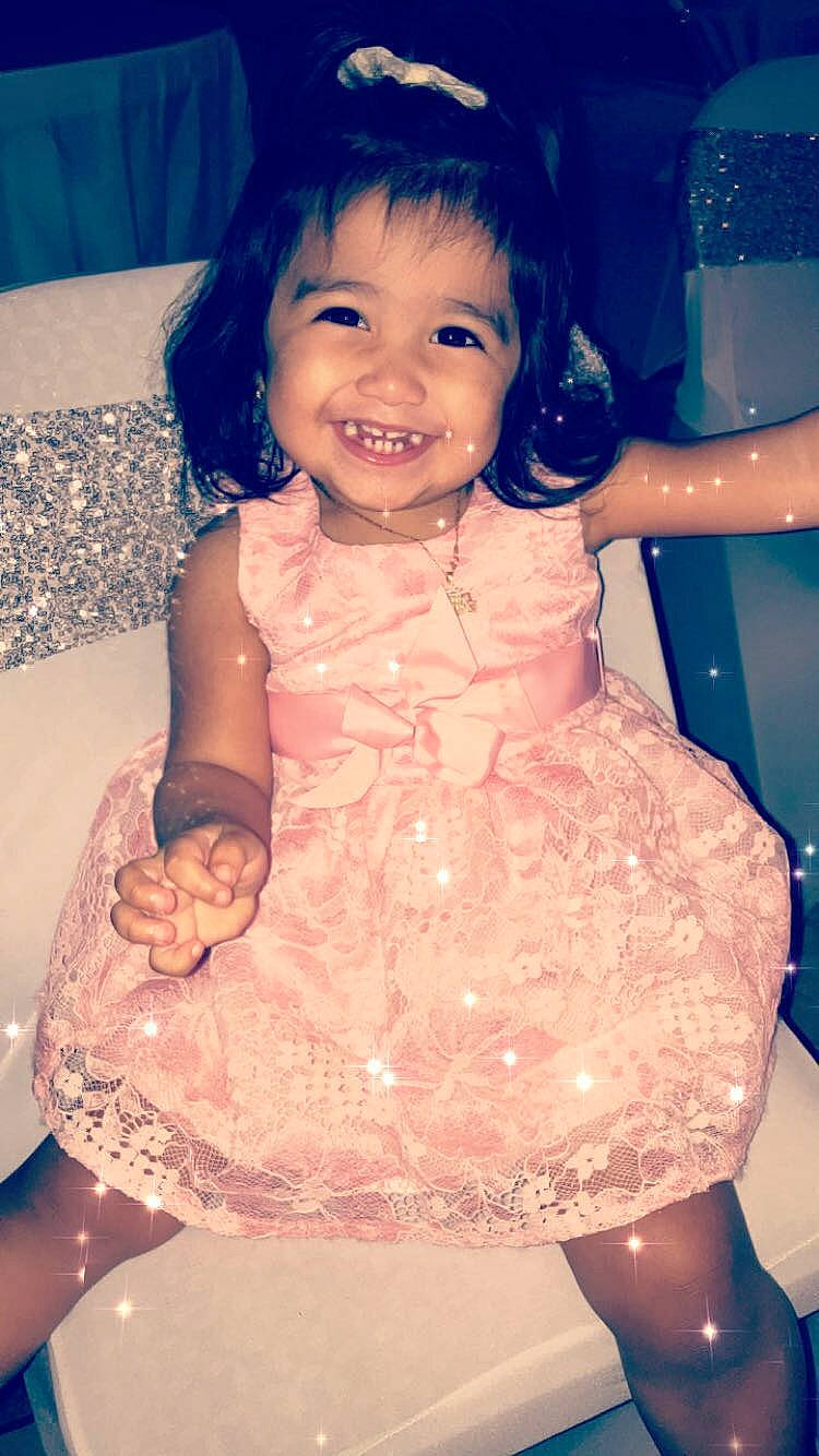 Mila is registered to the contest to win money with this photo: baby, birthday, cheek, child, dress, face, facial_expression, fun, happy, head, joy, leg, party, person, pink, sitting, skin, smile, toddler, water