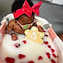 baby, bathtub, celebration, child, cute, fruit, headband, indoor, milk, milk_bath, number_5, pink_sunglasses, playful, portrait, red_bow, relaxing, strawberries, toddler, water, wooden_sign