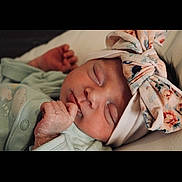 Liyah participe au concours pour gagner de l'argent avec cette photo : baby, newborn, sleeping, headband, floral, infant, cute, peaceful, skin, hand, clothing, soft, portrait, child, resting, indoors, closeup, babywear, tender, sleep
