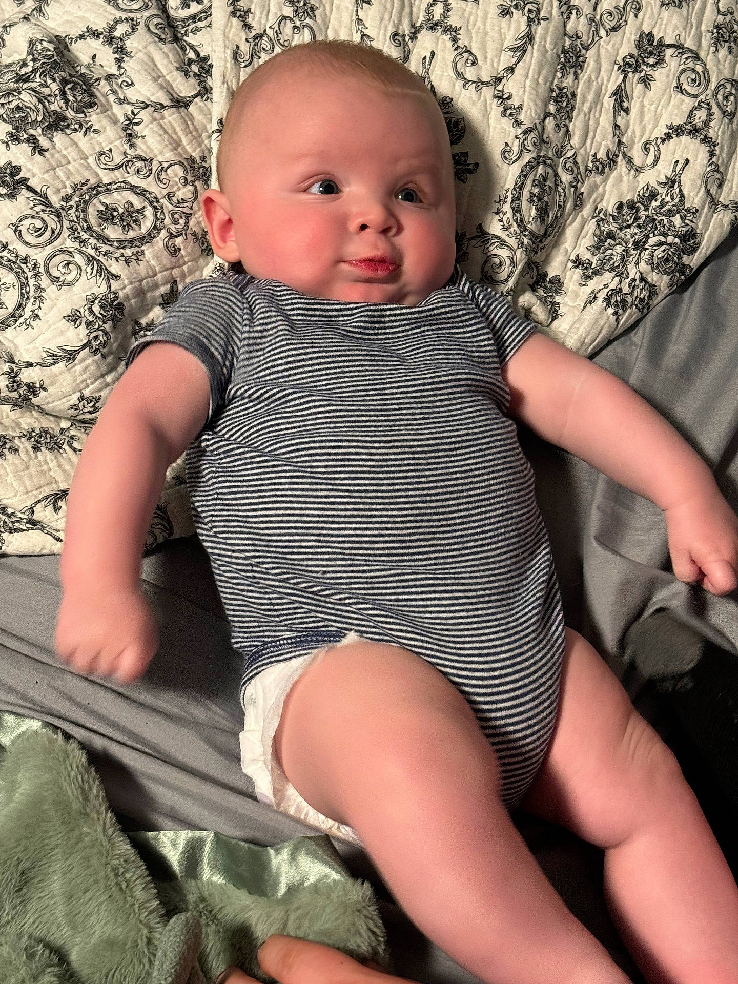 James is registered to the contest to win money with this photo: baby, bodypart, clothing, couch, cushion, diaper, dress, face, finger, furniture, hand, head, homedecor, newborn, person, photography, portrait, shorts, sitting, t_shirt