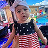 baby, child, infant, portrait, face, wide_eyes, outdoor, backyard, summer, pool, poolside, patriotic, stars_and_stripes, dress, headband, pink_bow, smiling, hand, toys, blue_sky