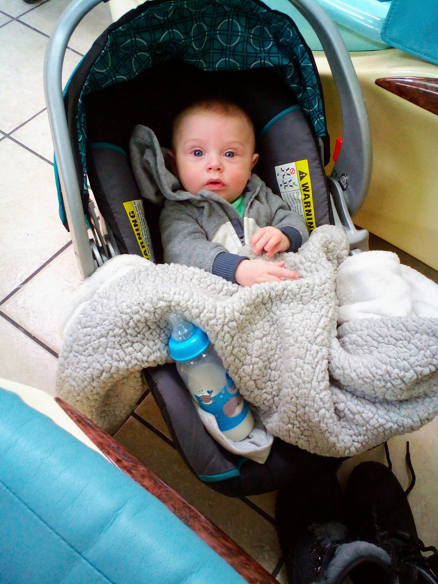 Dennis is registered to the contest to win money with this photo: arm, auto_part, baby, baby_carriage, baby_products, baby_safety, baby_toddler_clothing, blue, car_seat, cheek, child, comfort, electric_blue, human_leg, lap, nail, person, product, sitting, surprise