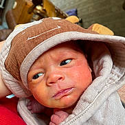 Raelynn is registered to the contest to win money with this photo: newborn, baby, infant, wrapped, blanket, hat, face, skin, hands, curious, indoors, soft, cozy, closeup, portrait, person, child, cute, newborn_hat, expression