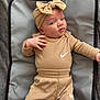 Freya joined the competition — help win amazing prizes! baby, infant, headband, bow, clothing, nike, outfit, gray_mat, soft_texture, lying_down, skin, hand, face, eyes, expression, cute, child, person, indoors, casual