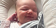 Freya is registered to the contest to win money with this photo: newborn, baby, sleeping, blanket, striped, cushion, baby_nest, soft, peaceful, infant, face, hand, clothing, rest, cozy, portrait, cute, indoors, closeup, relaxation
